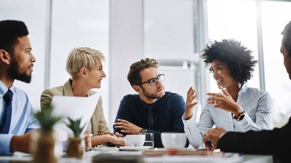 Life sciences professionals discussing QA budget in an office | Scilife