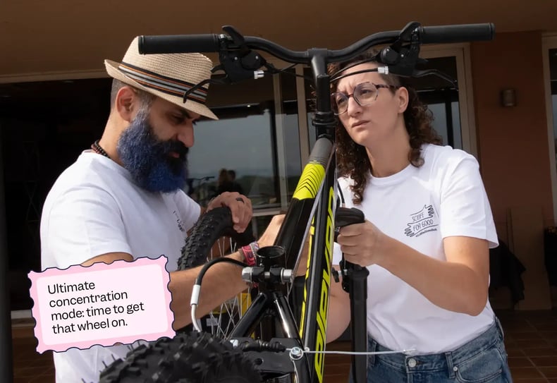 Two Scilife employees attaching a wheel to a bike | Scilife