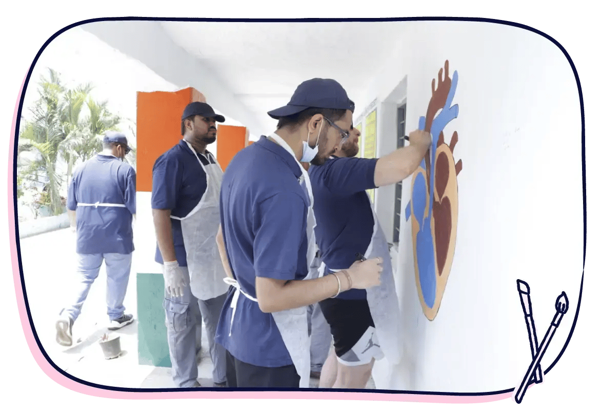 Scilife volunteers work together on a school mural, adding color, care, and creativity to a classroom space in Bangalore | Scilife