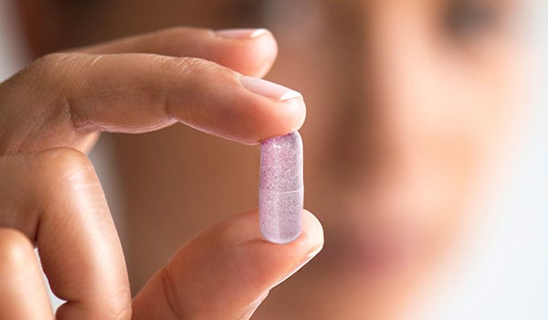 Customer story image from Pendulum showing a hand holding a capsule | Scilife