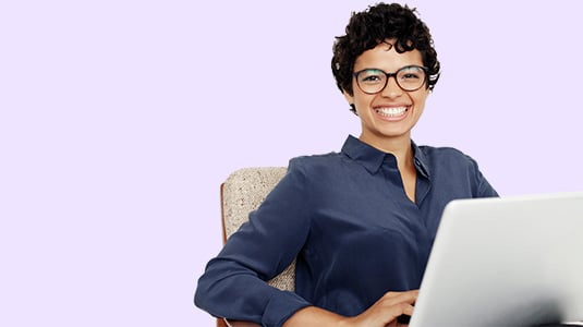 Smiling woman with a laptop to illustrate the Scilife's Plans & Pricing page
