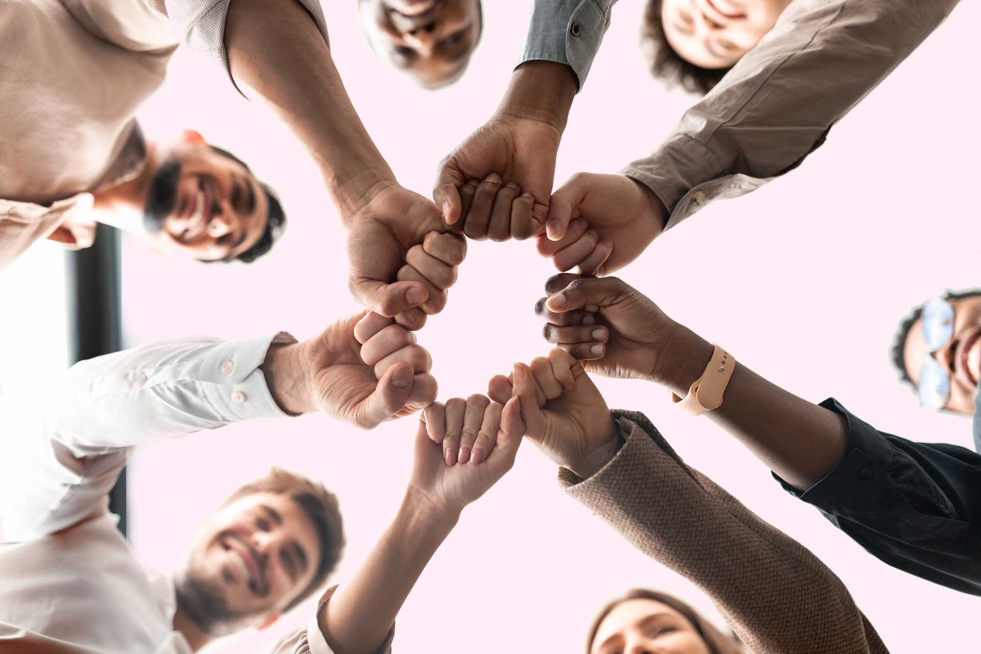 Work team bumping their fists on a circle to illustrate the collaborative spirit of the new Scilife Partnership Program