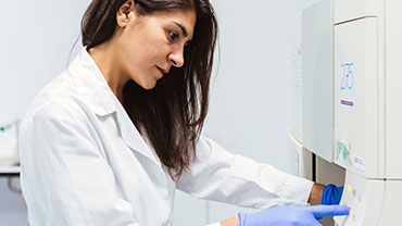Quality Assurance professional working with lab equipment