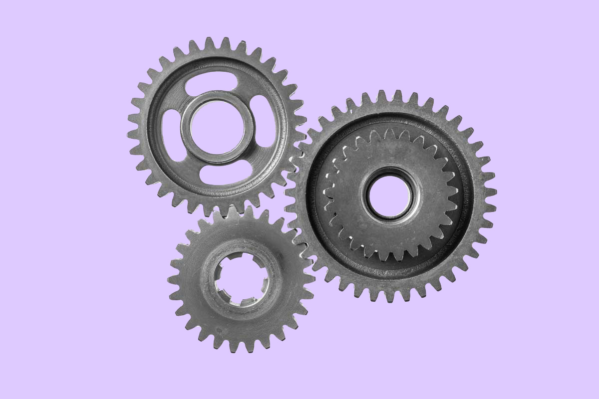Picture of a gear on purple background to represent the importance of team training on the Life Sciences companies