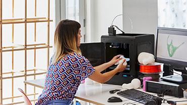 Girl taking out a prototype of a 3d printer to illustrate Scilife Software Platform for Medical Devices